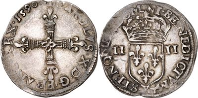 a silver coin with a cross on the front and a crown on the back