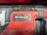 a close up of a red drill with a black handle