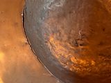 a large metal bowl sitting on top of a table