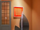 une sculpture au milieu d'une pièce aux murs orange
