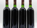 three bottles of wine sit side by side on a white surface