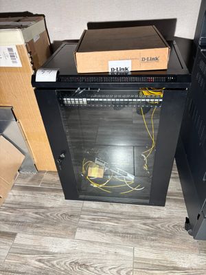 a black cabinet with a glass door in a room