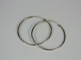 two silver hoop earrings on a white surface
