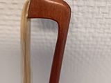 a close up of a wooden stick with a long hair