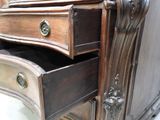 a dresser with two drawers and a mirror in it