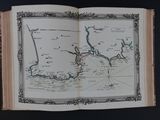 an open book with a map on it sitting on a table