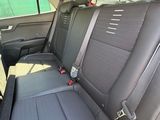 the back seats of a red car with a black seat belt