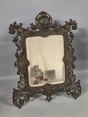 an antique silver picture frame with a picture of a castle in the background