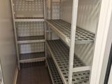 a small room with shelves and shelves in it