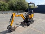 an image of a small excavator parked in a parking lot