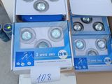 four boxes of light bulbs sitting on top of a cardboard box