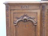 a wooden cabinet with carvings on the top of it