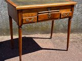 a small wooden table with two drawers on top of it