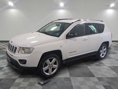 une photo d'une Jeep Compass blanche garée sur un sol à damier