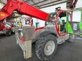 a red crane that is sitting in a garage