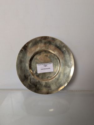 a silver plate sitting on a table with a label on it