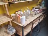 a wooden shelf with bottles and jars on top of it