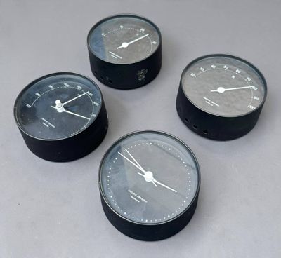 quatre horloges noires et blanches posées sur une table