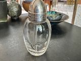 a glass salt and pepper shaker sitting on a table