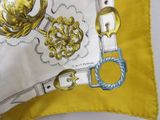 a yellow pillow with a picture of a pair of scissors on it