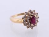 a close up of a gold ring with a ruby stone