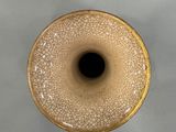 a close up of a vase with a black hole in it