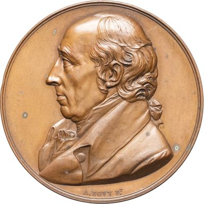 une image représentant un médaillon en bronze à l'effigie d'un homme aux cheveux longs et à la barbe