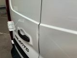 a white van parked in a parking lot next to a building