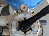 a close up of a blue tank with a wrench on it