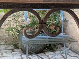 a wicker basket sitting on top of a metal bench