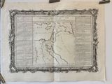 an old map hanging on a wall next to a pair of scissors