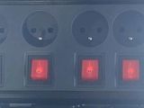 three lights that are on the side of a building