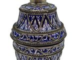 a blue and white vase with a lid on a white background