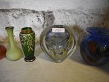 several vases are lined up on a shelf next to a brick wall