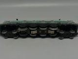a close up of a train engine on a white surface