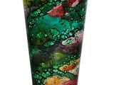 a glass vase with a green and pink design on it