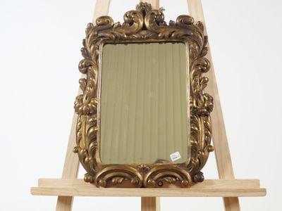 a wooden easel with a mirror on top of it