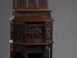 une grande armoire en bois ornée de sculptures sur le dessus