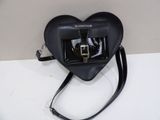 a black heart shaped bag with a camera attached to it