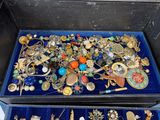 many different types of jewelry in a blue case