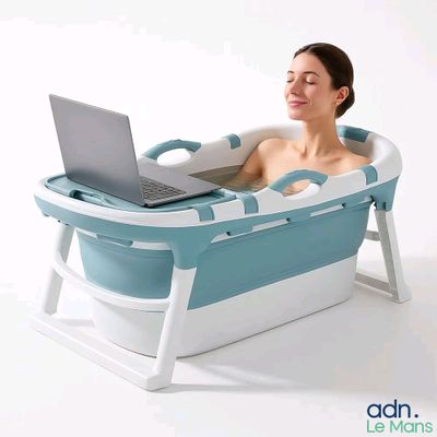 a woman sitting in a bath tub with a laptop on her lap