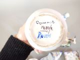 a person holding a cup of coffee with writing on it