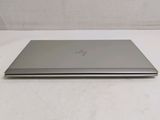 the laptop is sitting on a white surface with a white background