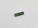 a piece of green tourmaline on a white surface