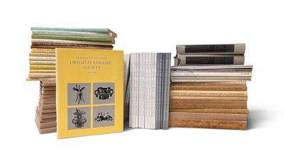 several books are stacked on top of each other on a white surface