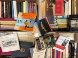a lot of books that are on a shelf