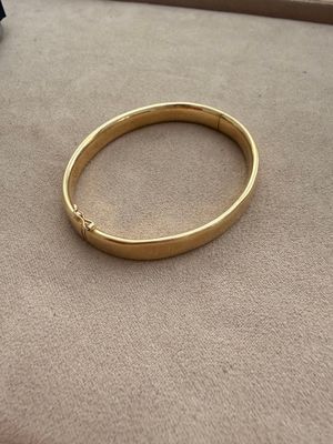 a close up of a gold ring on a carpeted surface