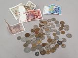 a pile of coins and money on a table