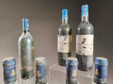 many bottles of wine on display in a glass case