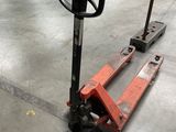 an image of a fork lifter sitting on a concrete floor